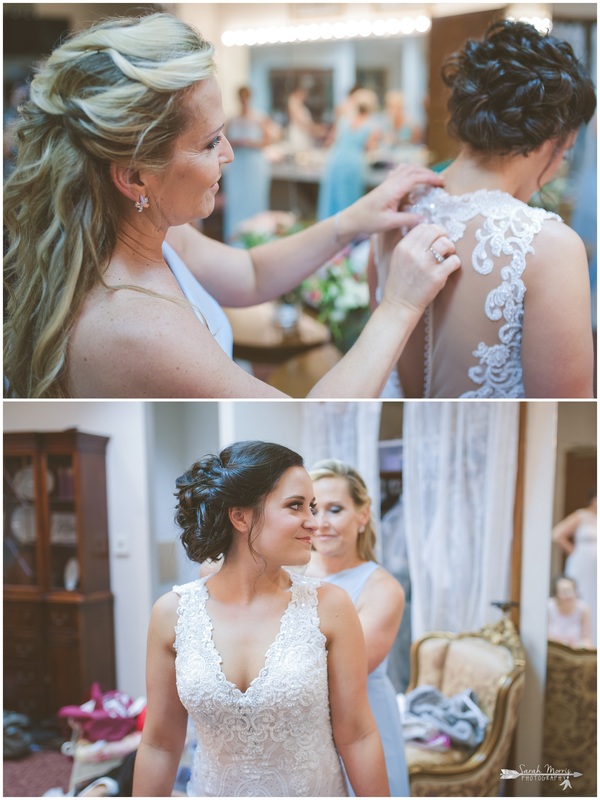 Mother of the bride buttoning bride's dress in the bride's room at Bellevue Baptist Church