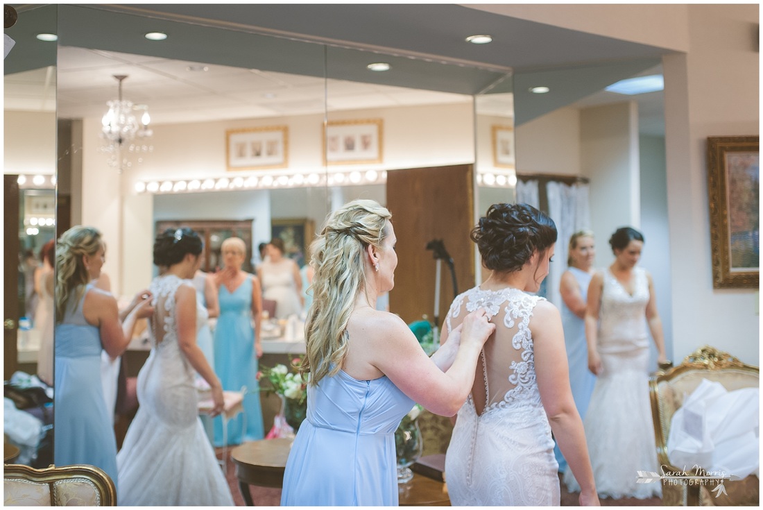 Mother of the bride buttoning bride's dress in the bride's room at Bellevue Baptist Church
