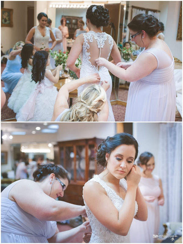 Mother of the bride buttoning bride's dress in the bride's room at Bellevue Baptist Church