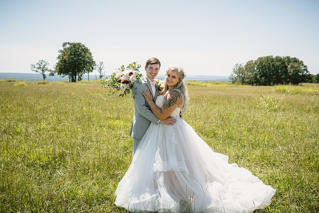 bride and groom wedding photos on love mountain at the wedding barn in arkansas