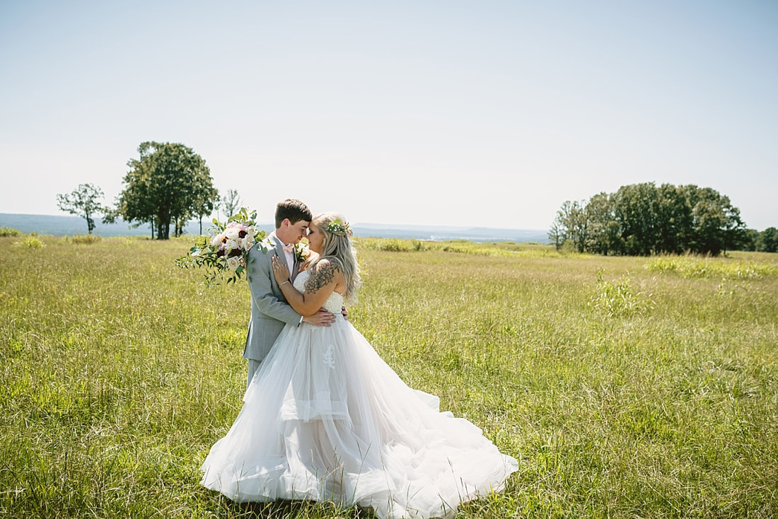 bride and groom wedding photos on love mountain at the wedding barn in arkansas