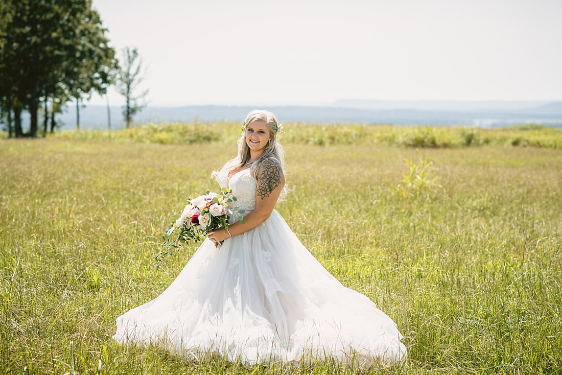 bride and groom wedding photos on love mountain at the wedding barn in arkansas