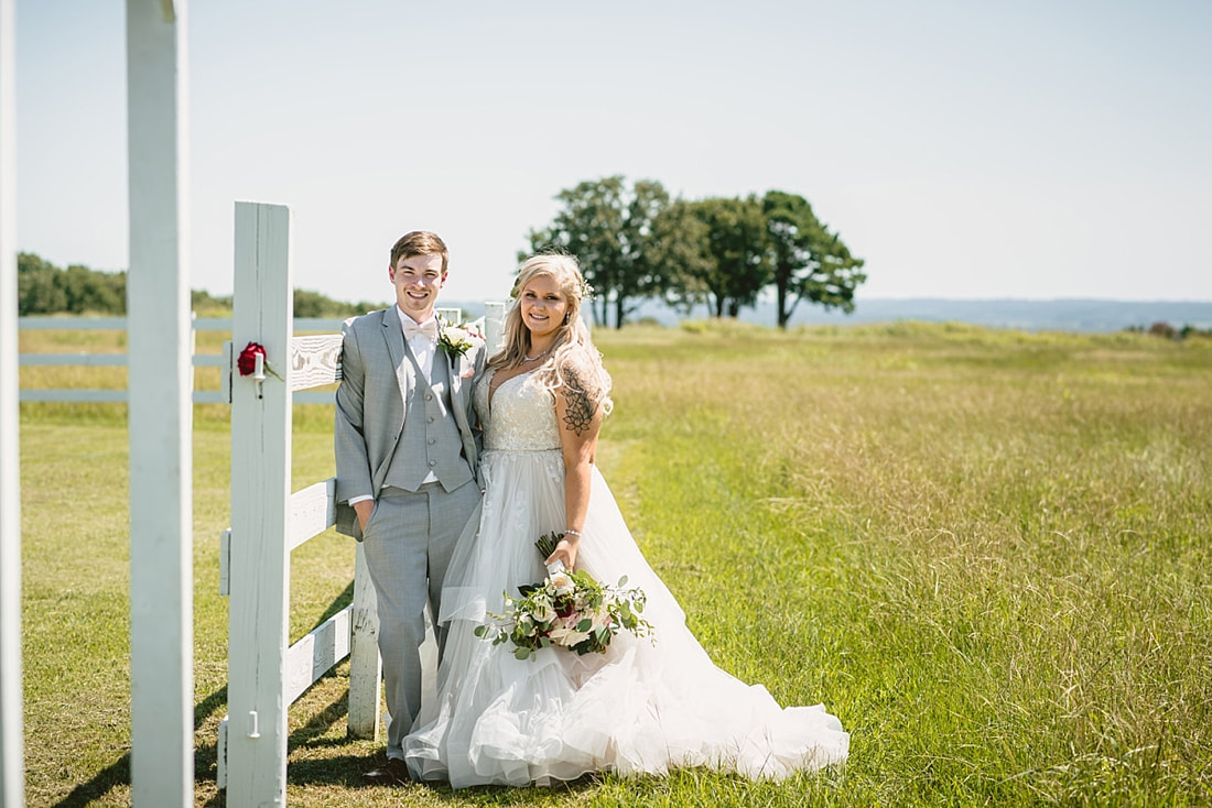 bride and groom wedding photos on love mountain at the wedding barn in arkansas