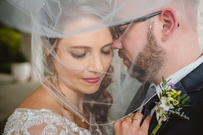 wedding photos of bride and groom under wedding veil + Memphis, TN wedding