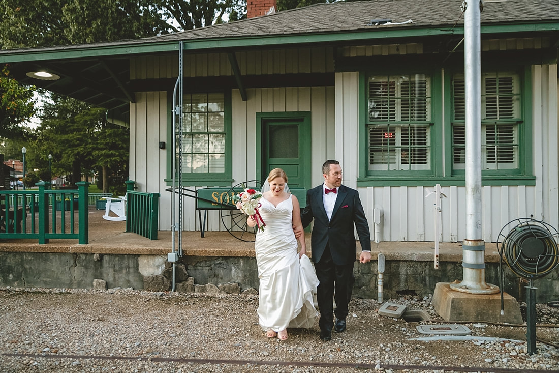 bride and groom walking through Collierville Town Square