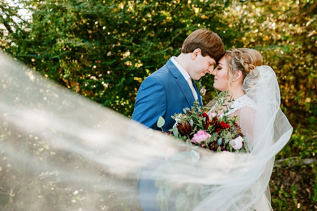 Bride and Groom + forehead kiss + wedding veil + Cypress Hall Hernando, MS