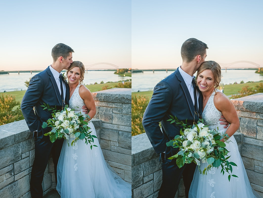 bride and groom in front of the m bridge over the mississippi river downtown memphis