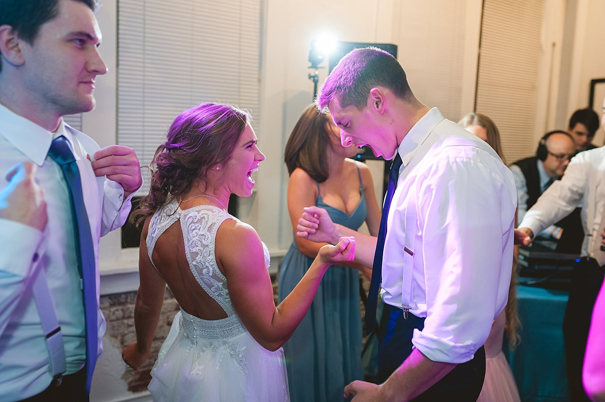 bride and groom singing and dancing at their wedding reception at the robinson gallery downtown memphis