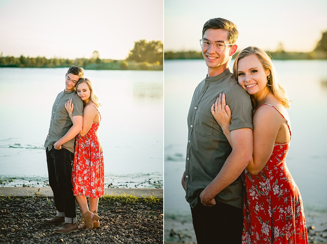 couple posing for engagement photos by the lake at shelby farms park in memphis, tn