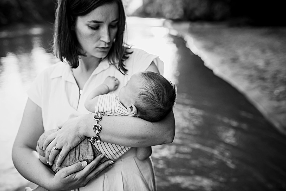 mother holding newborn baby at the Wolf River in Memphis, TN
