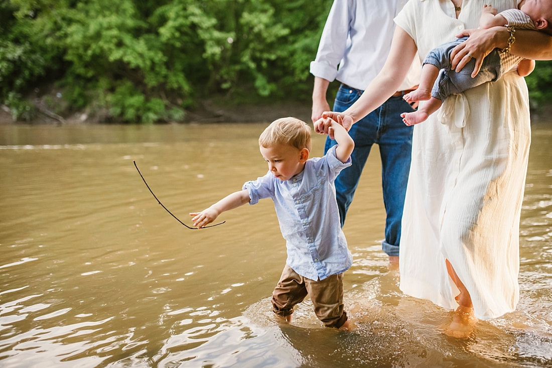 child playing with a stick at the Wolf River in Memphis, TN