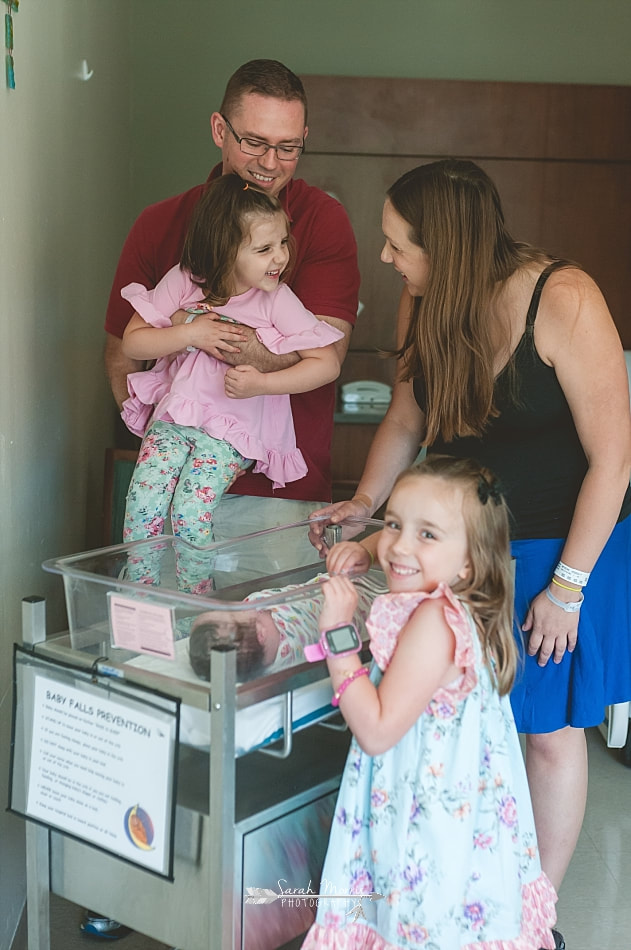 Family gathered around their newborn baby at Methodist Le Bonheur Germantown Hospital