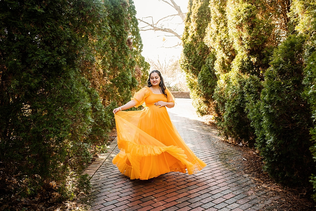 pregnant mother wearing orange Indian dress at memphis botanic gardens