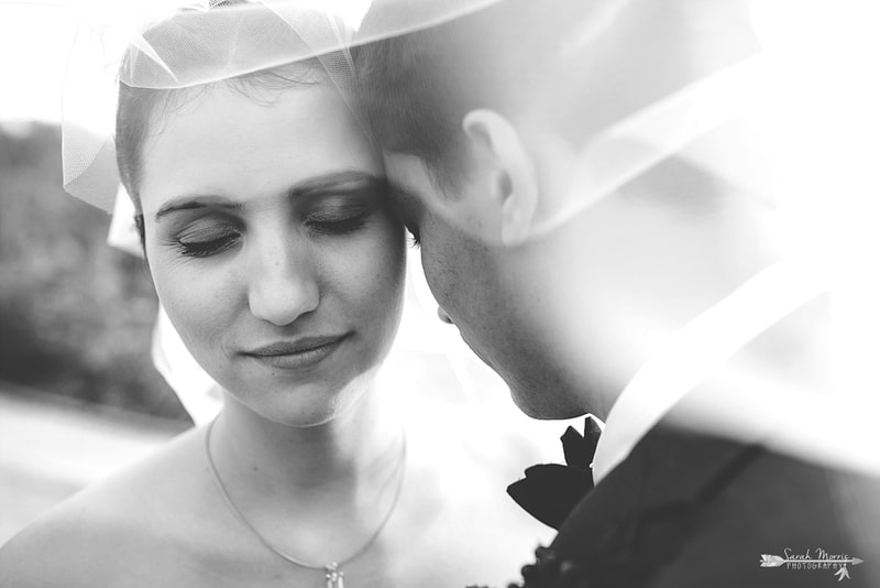 close up of bride's face under the wedding veil