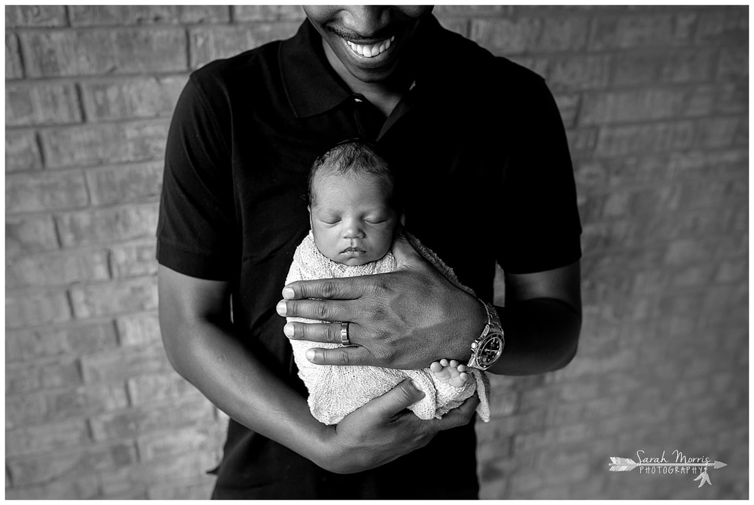 newborn photos of baby girl in daddy's hands