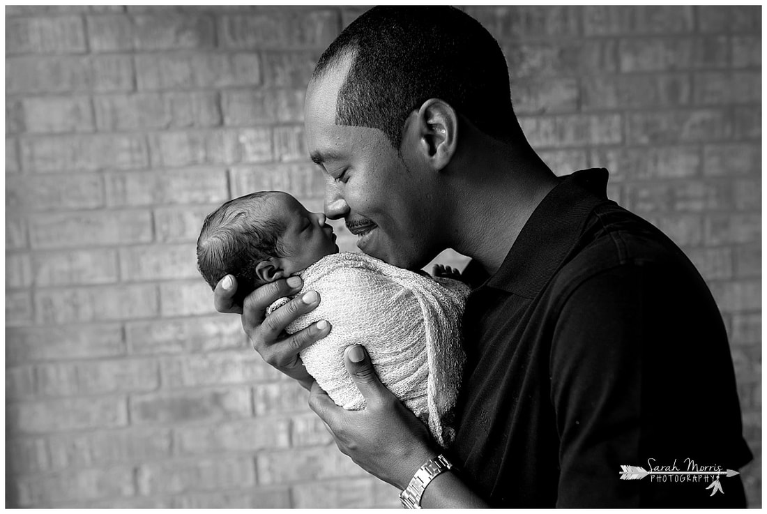 newborn photos of baby girl in daddy's hands