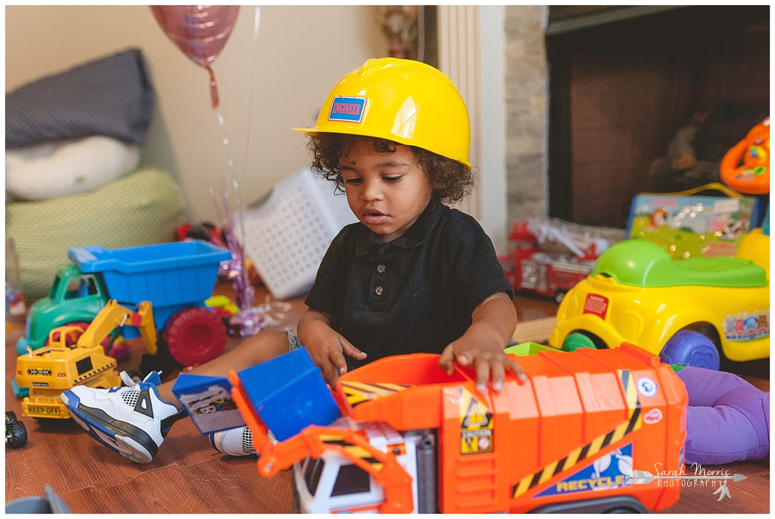 lifestyle portrait of toddler boy playing with toys