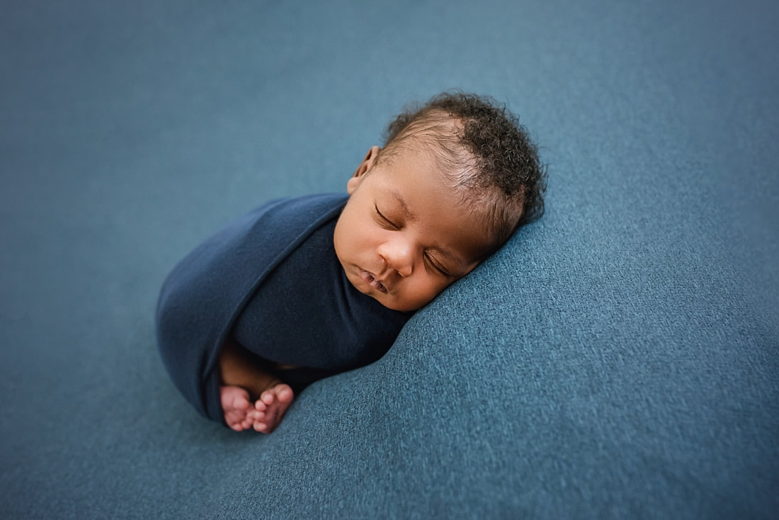 newborn baby wrapped in blue for newborn session in Memphis, TN