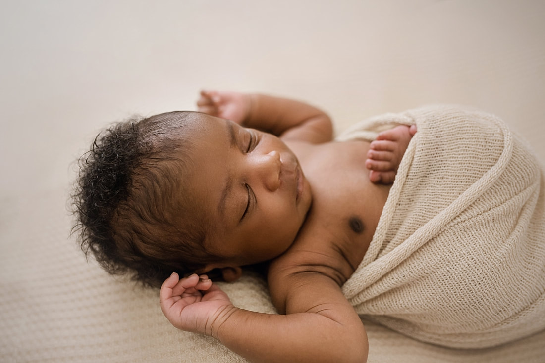 newborn baby wrapped in tan for newborn session in Memphis, TN