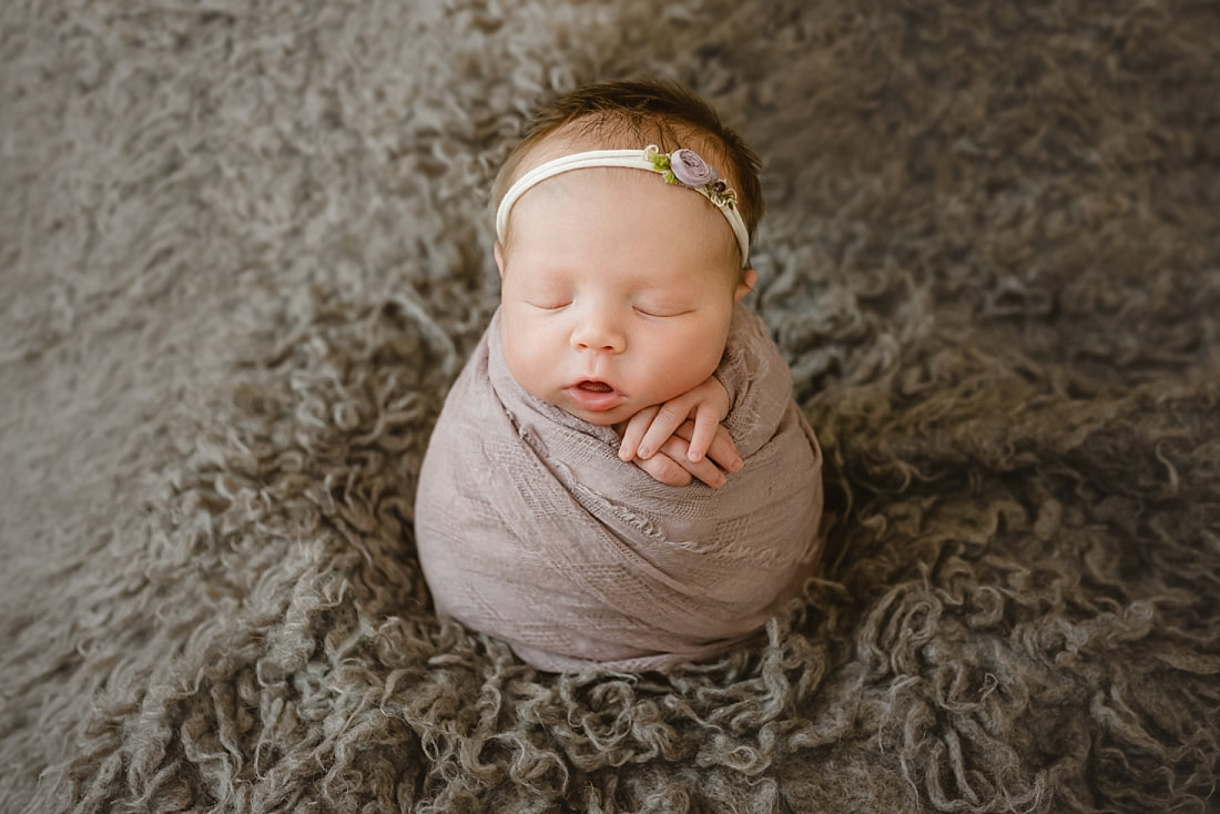 baby girl swaddled in mauve blanket for newborn photography in Memphis, TN