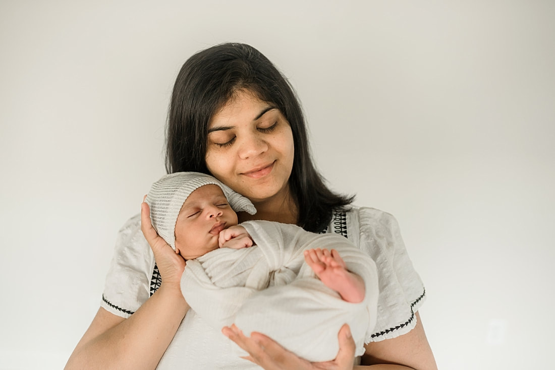 mom holding swaddled newborn baby in Memphis, TN