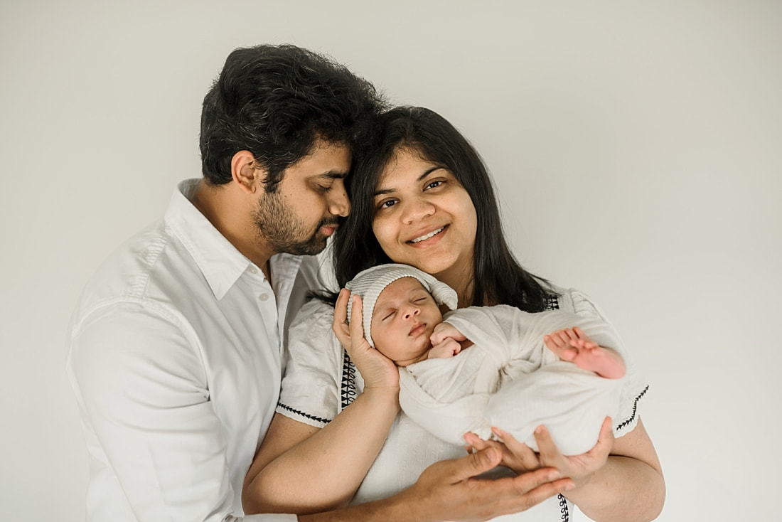 parents holding swaddled newborn baby in Memphis, TN
