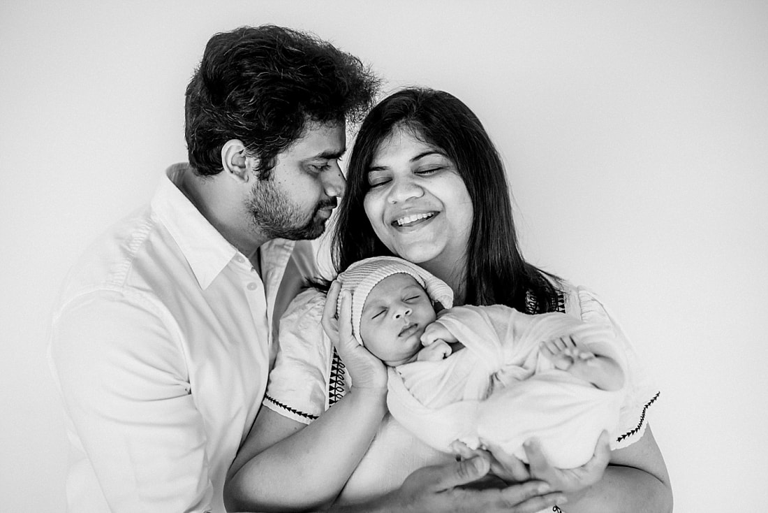 parents holding swaddled newborn baby in Memphis, TN