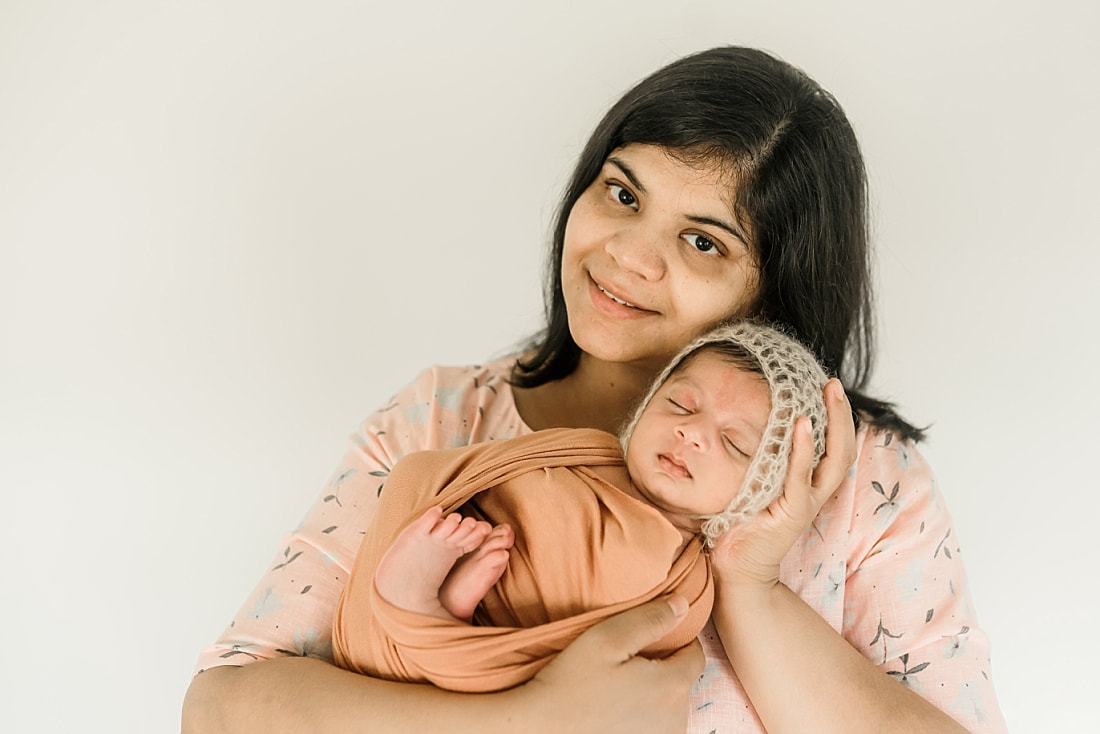 mom holding swaddled newborn baby in Memphis, TN
