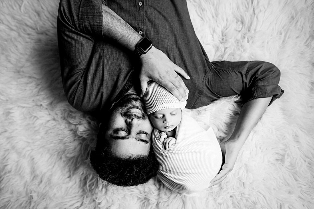 Newborn baby boy swaddled held by dad for newborn portrait in Memphis, TN
