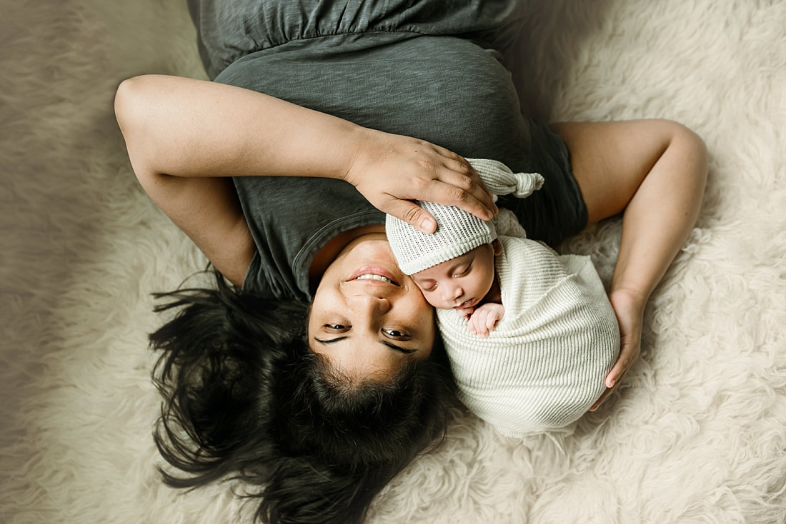 Newborn baby boy swaddled with mom for newborn portrait in Memphis, TN
