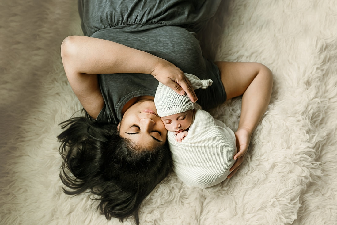 Newborn baby boy swaddled with mom for newborn portrait in Memphis, TN