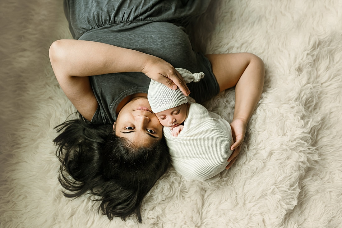 Newborn baby boy swaddled with mom for newborn portrait in Memphis, TN