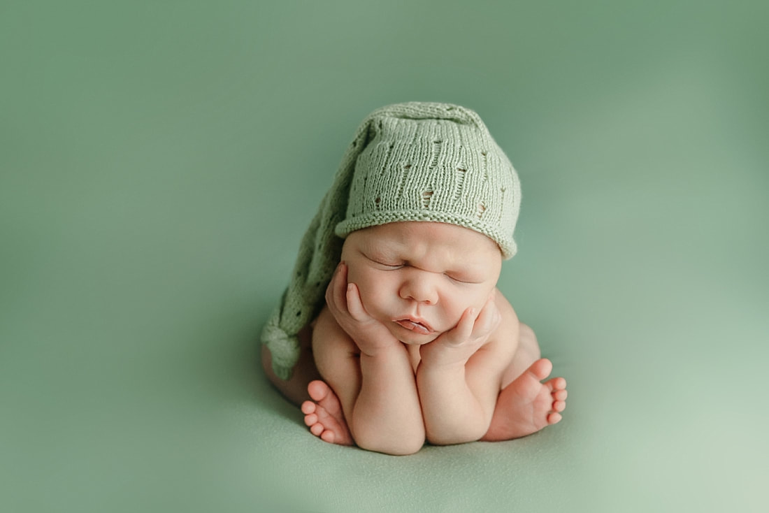 newborn baby posed on pastel yellow blanket for newborn portraits in Memphis, TN