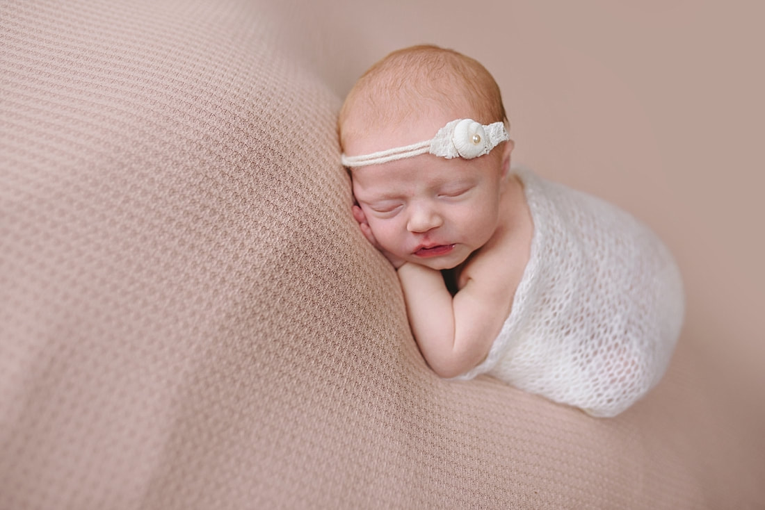 newborn baby sleeping on pink blanket for newborn photoshoot in Memphis, TN