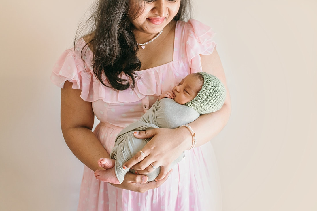 mother holding newborn baby boy during newborn session in memphis