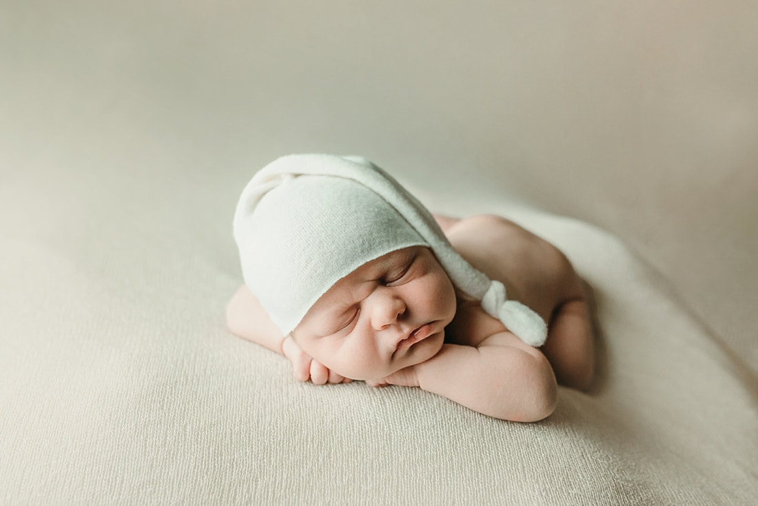 newborn baby boy posed and sleeping on tan blanket in Memphis, TN