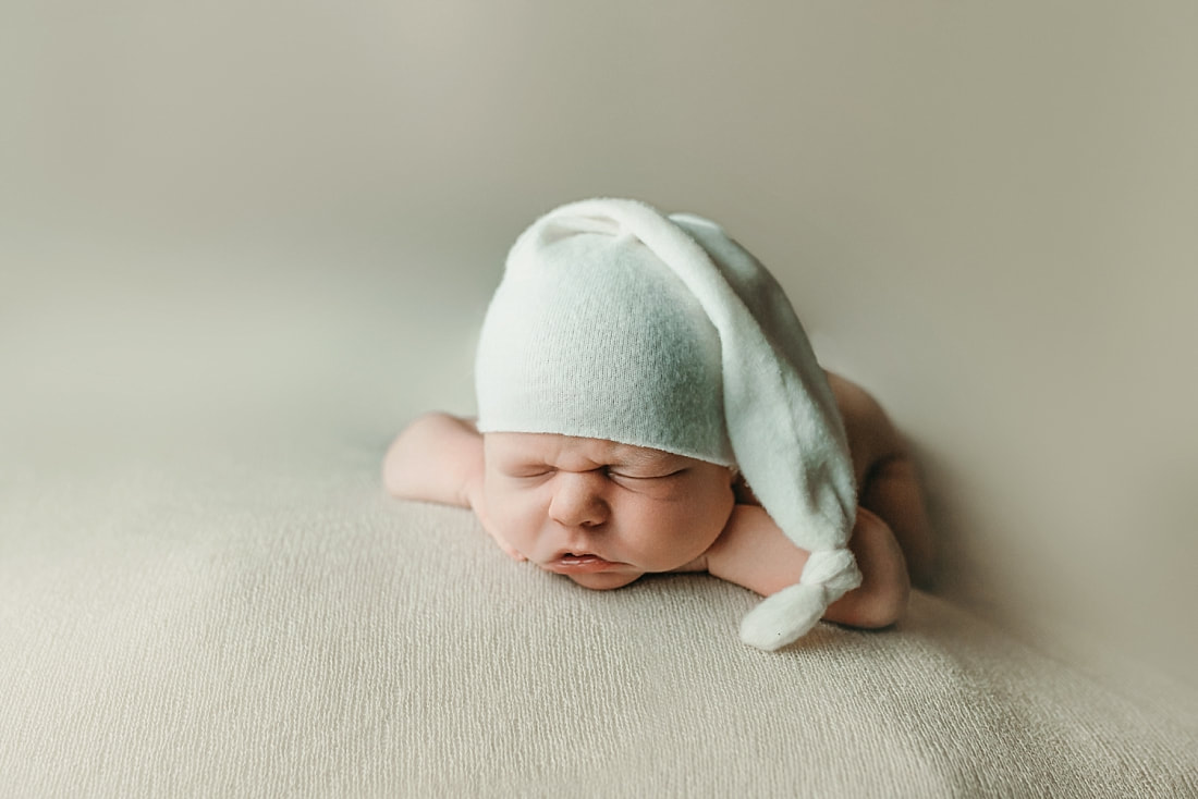 newborn baby boy posed and sleeping on tan blanket in Memphis, TN