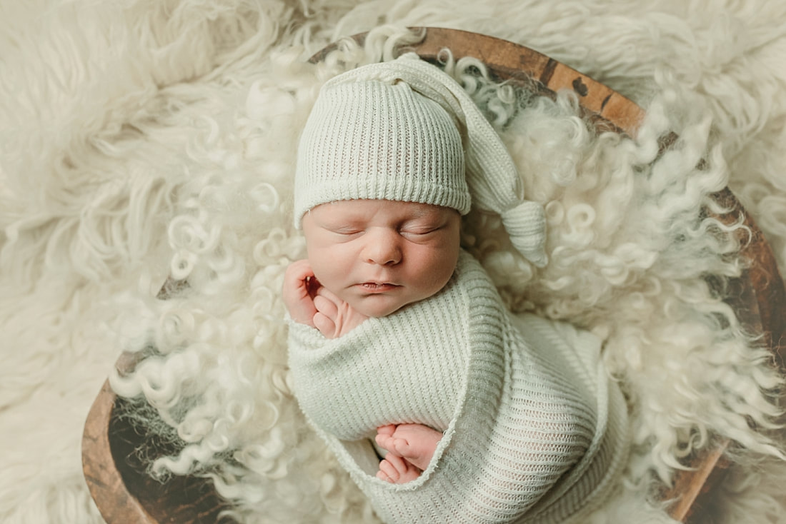 newborn baby wrapped in ivory blanket for newborn portraits in Memphis, TN