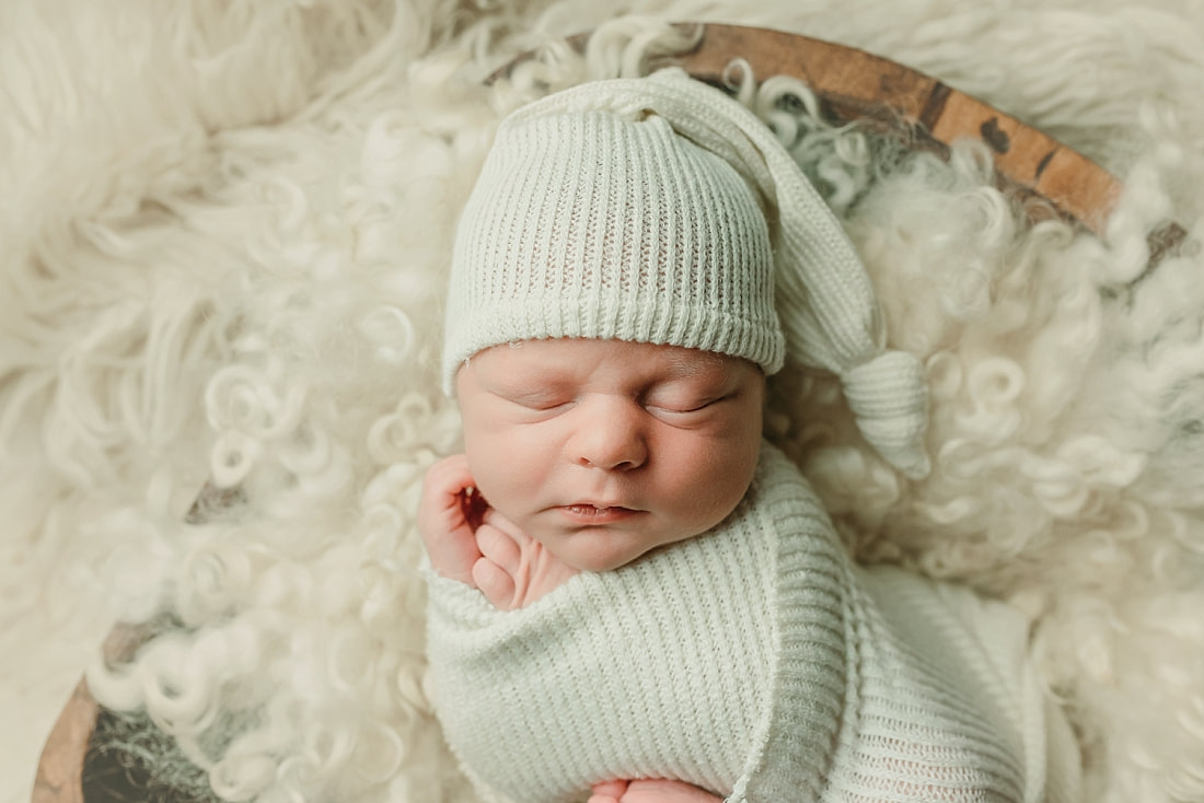 newborn baby wrapped in ivory blanket for newborn portraits in Memphis, TN