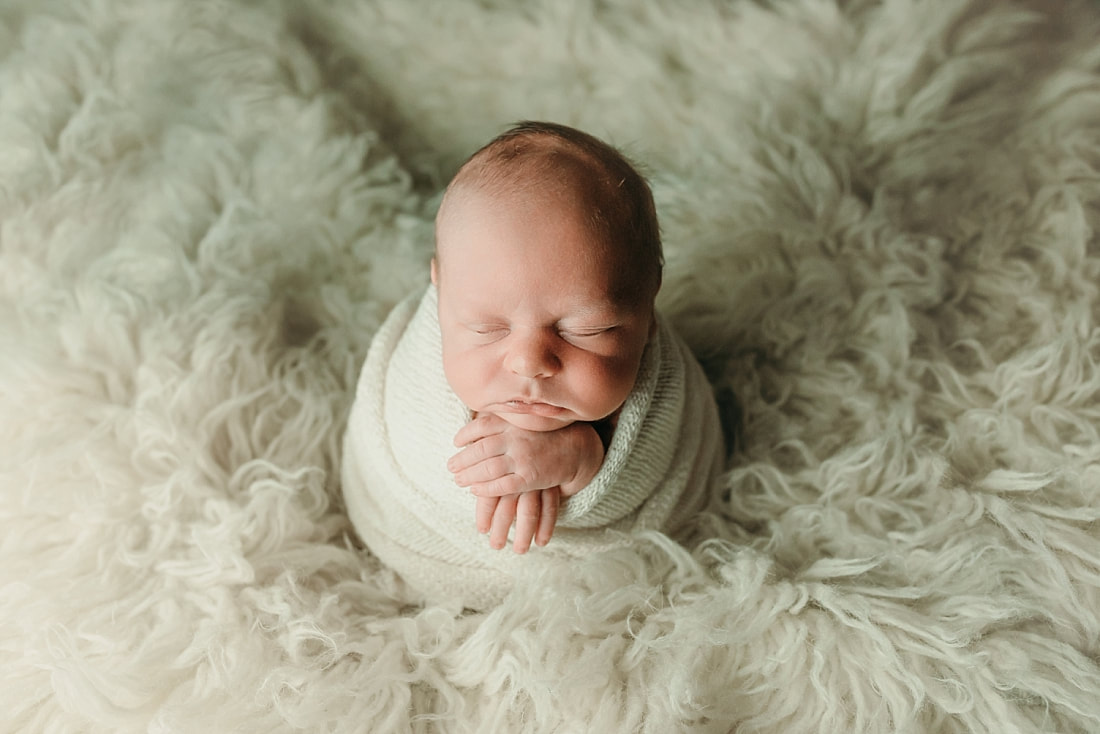 newborn baby wrapped in ivory blanket for newborn portraits in Memphis, TN