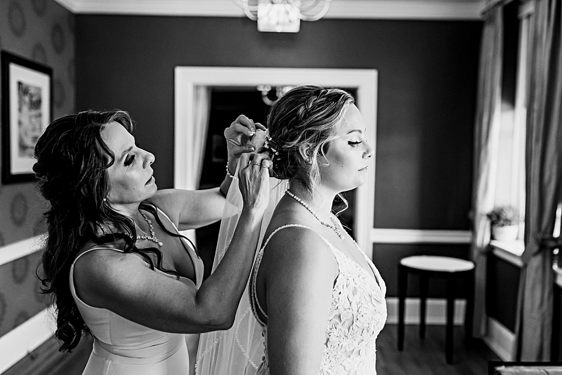 mother of the bride putting the bride's wedding veil in her hair + Pink Palace Wedding + Memphis, TN