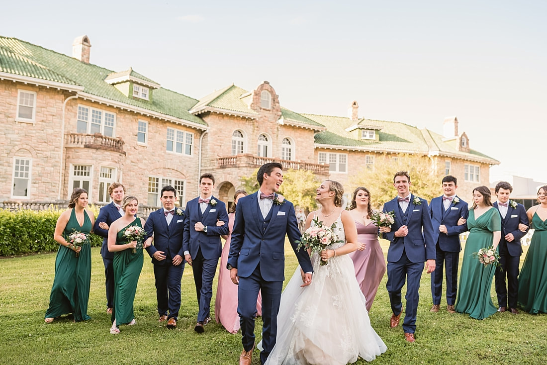 bride and groom laughing with their wedding party + Pink Palace Wedding + Memphis, TN