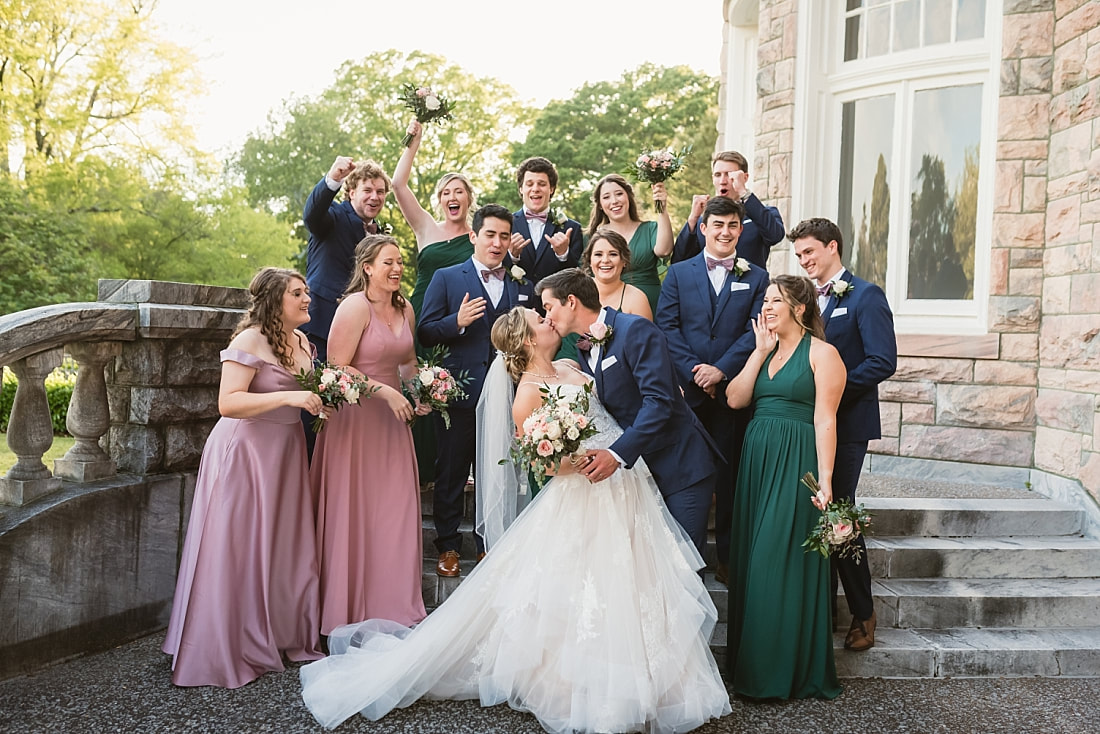 wedding party cheering as bride and groom kiss + Pink Palace Wedding + Memphis, TN