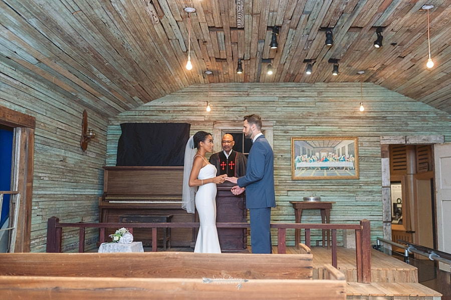 Bride and Groom getting married in the old country church exhibit at the Stax Museum