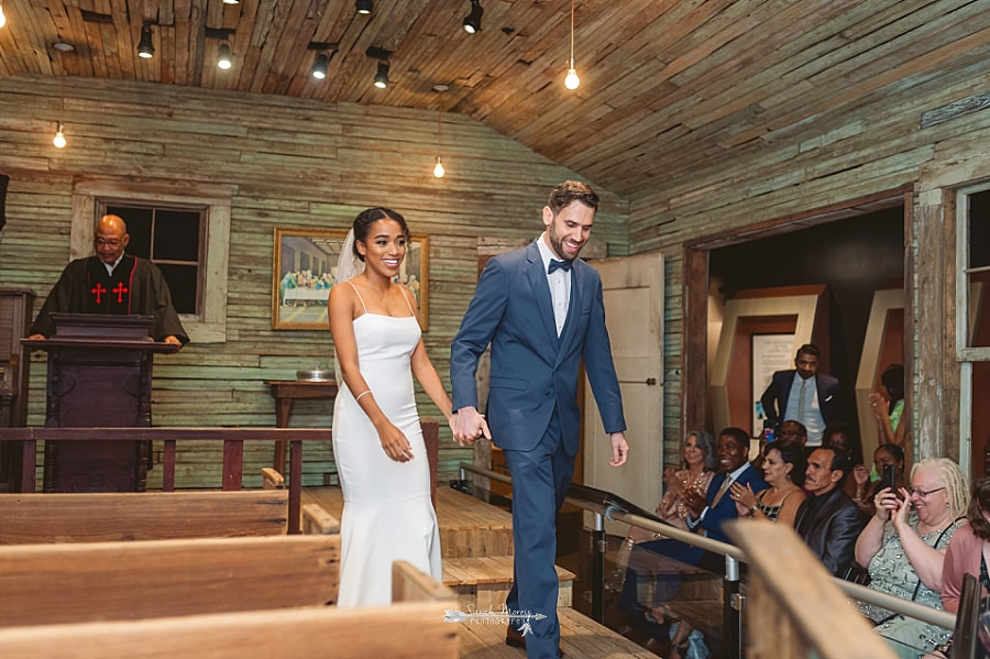 Bride and Groom getting married in the old country church exhibit at the Stax Museum
