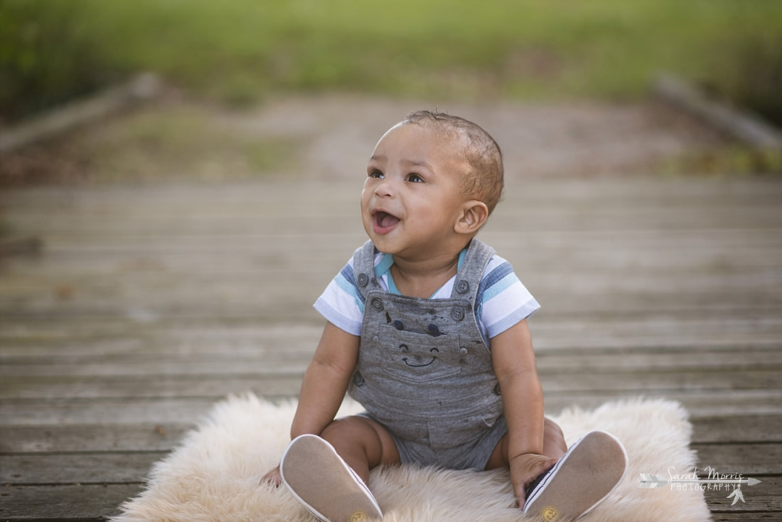 Baby sitting on walking bridge at Shelby Farms Park