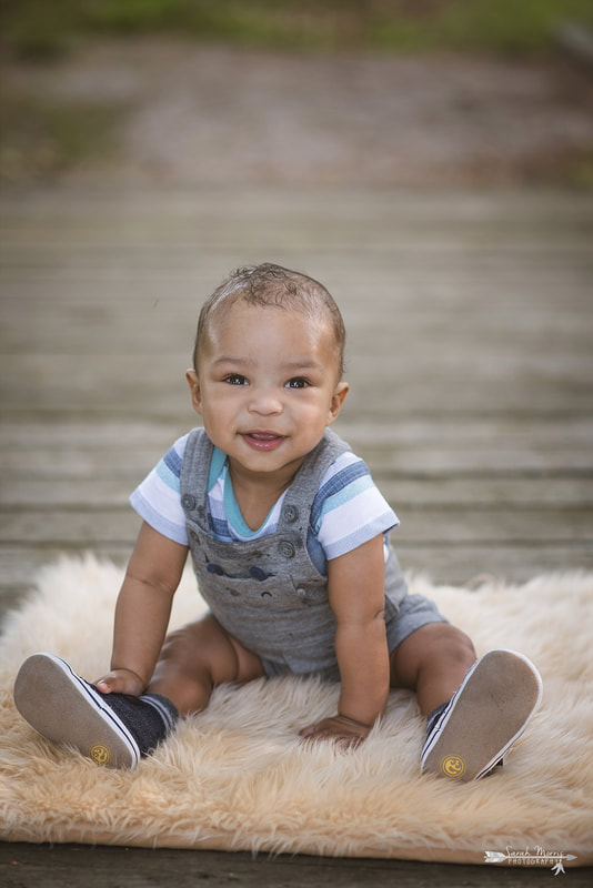 Baby sitting on walking bridge at Shelby Farms Park