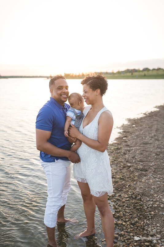 Family pictures on the bank of Patriot Lake at sunset at Shelby Farms Park