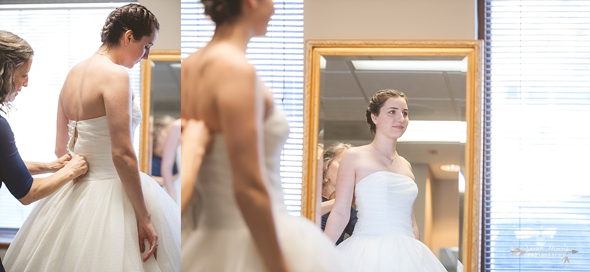 Mother of the bride buttoning bride's wedding dress at St. Francis of Assisi Catholic Church