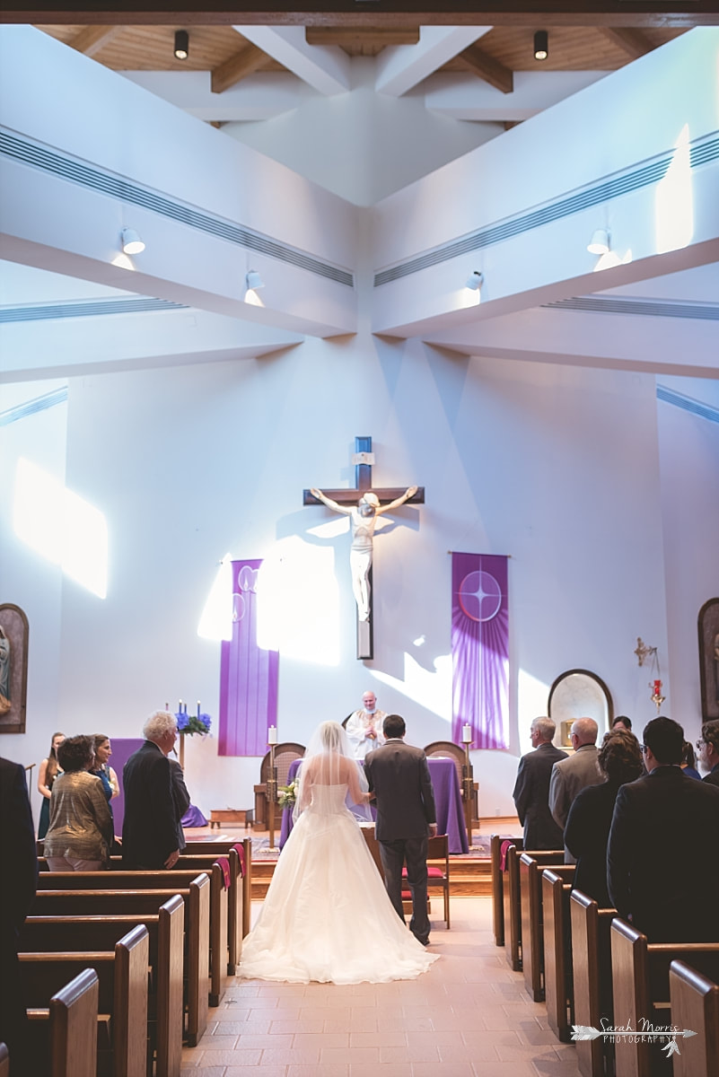 bride and groom approaching the alter at St. Francis of Assisi Catholic Church